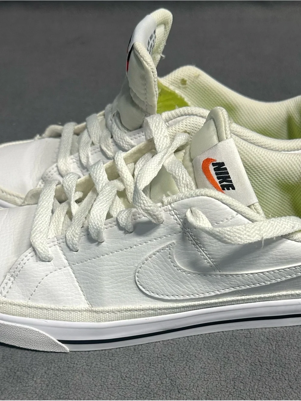 Nike White Mid-Top Sneakers with Orange Swoosh